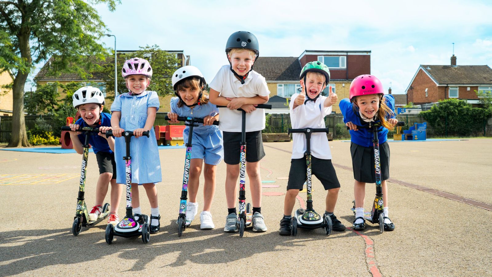 Children with LIFERYDER HALO and QUEST scooters outside school playground