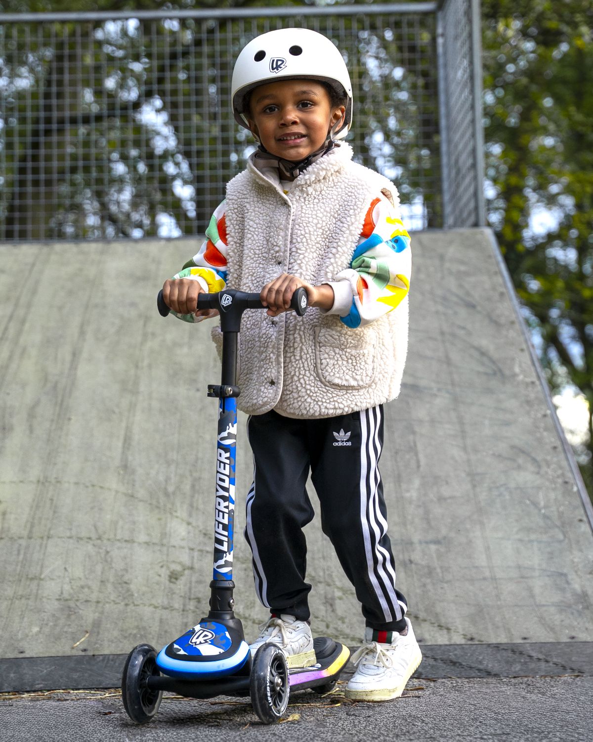 Child riding a LIFERYDER HALO 3 wheel scooter outdoors