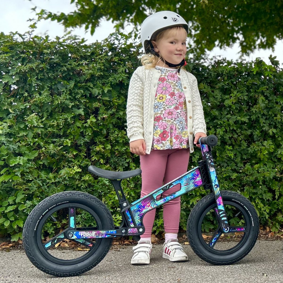 Child standing with a LIFERYDER VOGUE balance bike outdoors