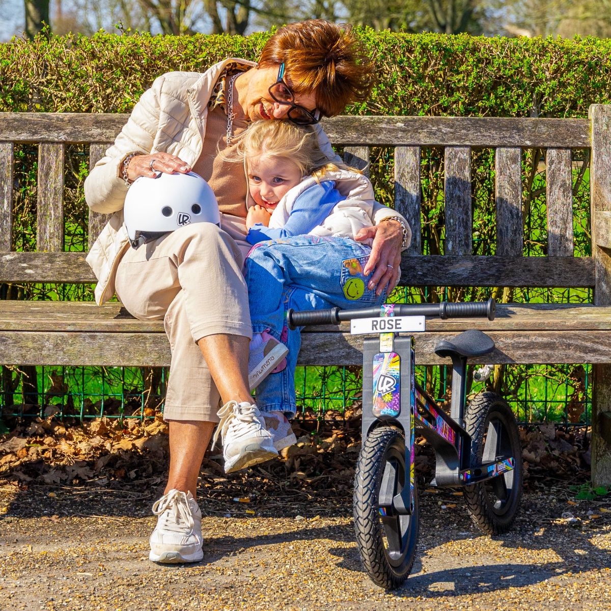 Woman and child sitting with a LIFERYDER VOGUE balance bike in a park