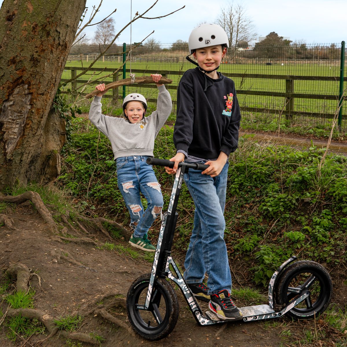 Children playing outdoors with a LIFERYDER INFINITY big wheel scooter