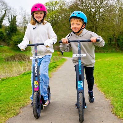 Children riding LIFERYDER scooters with personalised mini reg plates