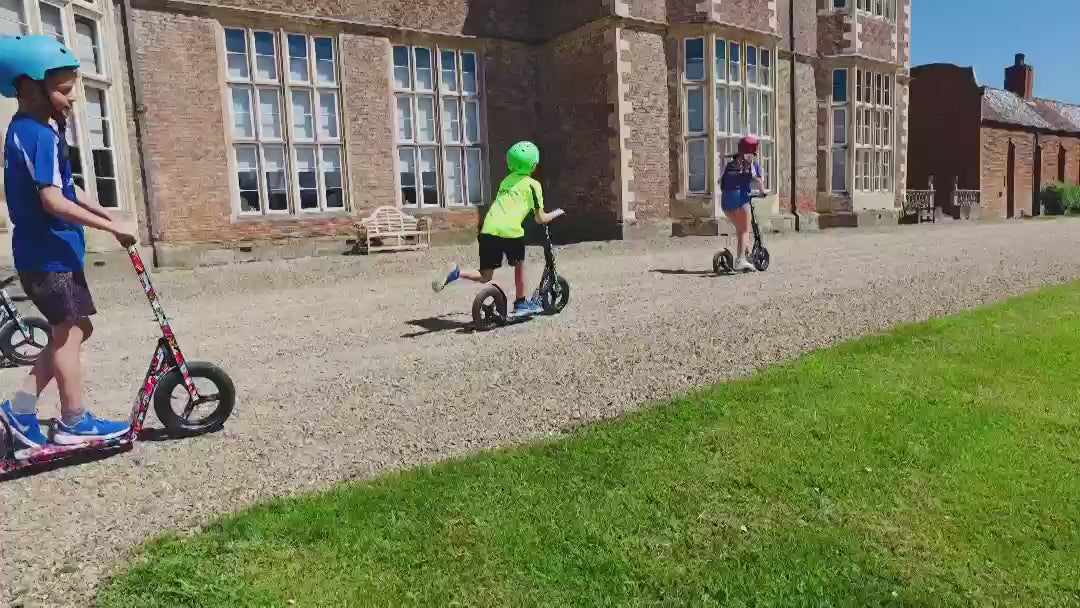 Load video: Children racing on LIFERYDER INFINITY big wheel scooters outdoors